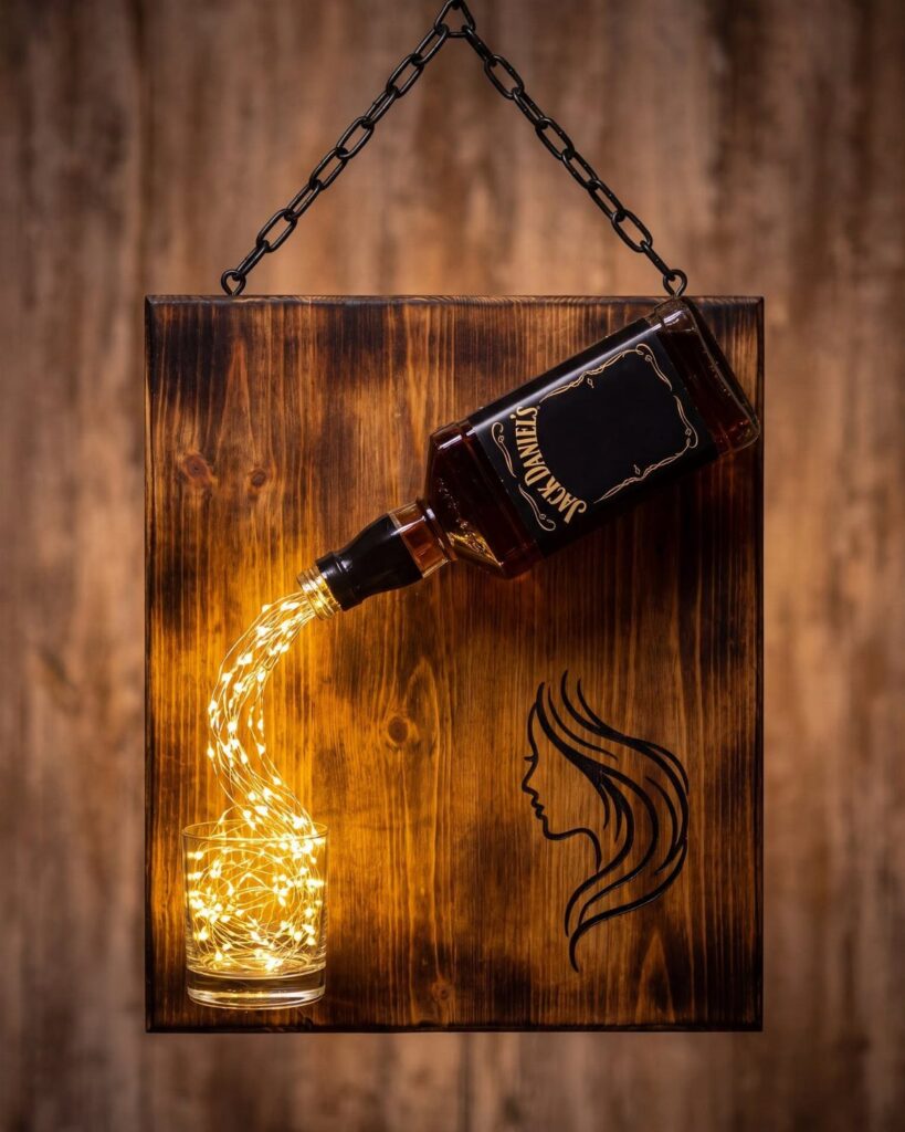 Wooden wall art featuring a bottle pouring glowing lights into a glass