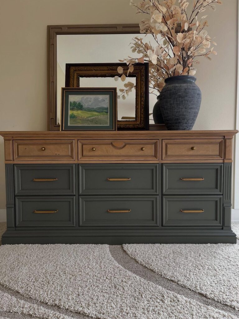 Dark grey-green painted dresser drawer fronts with natural wood top and gold handles.