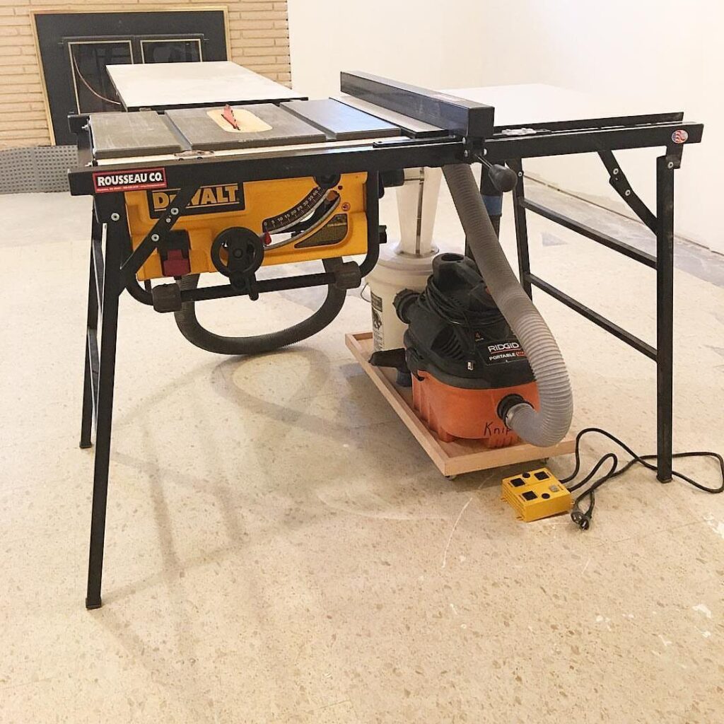 DeWalt table saw connected to a shop vacuum with a cyclone separator.
