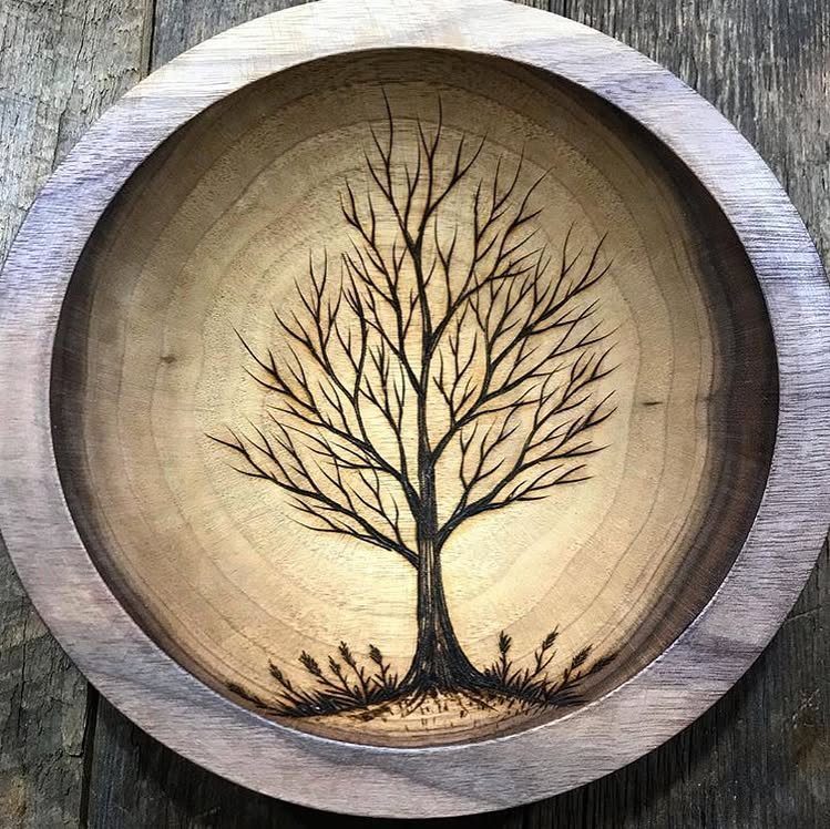 Wood burned tree pattern inside a circular wooden bowl with detailed branches.