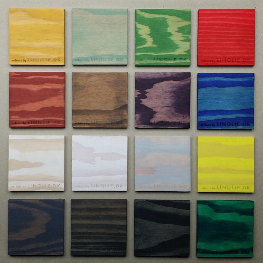Wooden square samples stained in various colors arranged in a grid layout.